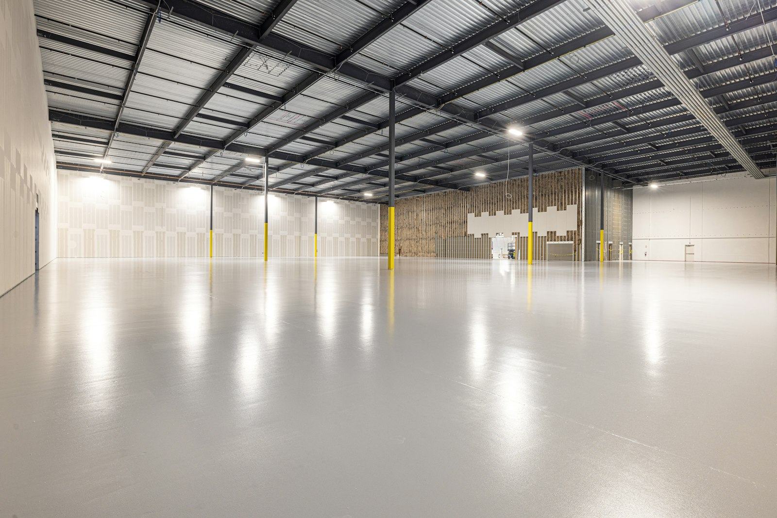 Glossy grey commercial epoxy floor with mirror reflection
