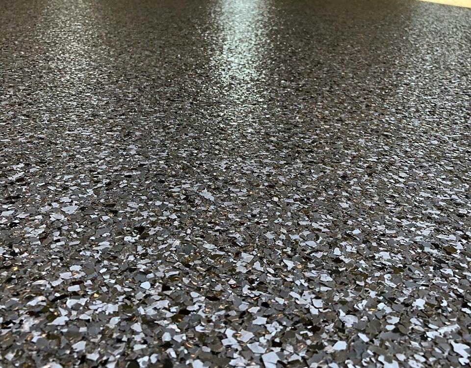 Macro close-up of dark flake epoxy with metallic sparkle