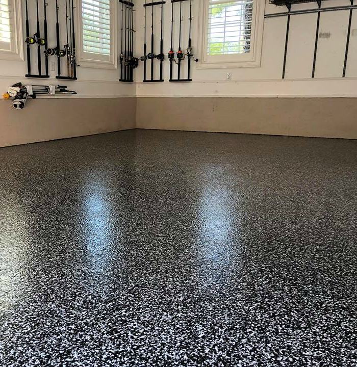 Black and white flake epoxy garage floor with high-gloss reflection