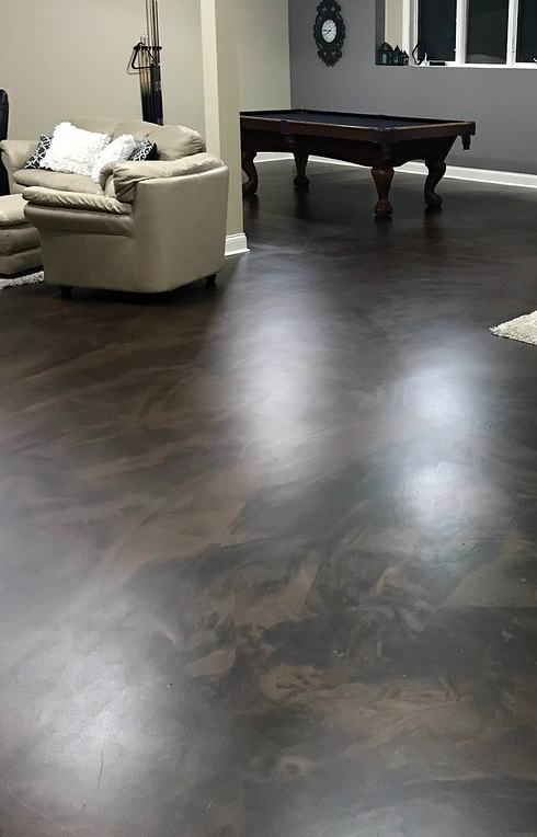 Espresso metallic epoxy floor in a finished basement lounge